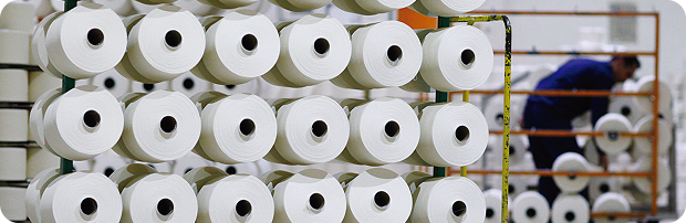 Industrial cable manufacturing facility with organized material reels in production area